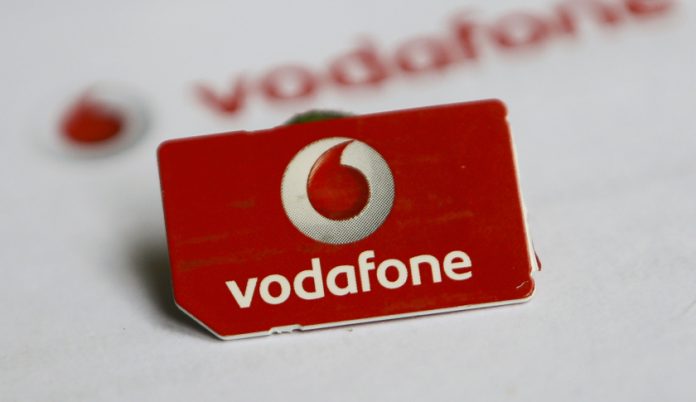 A SIM card of Vodafone is pictured in front of a letter of Vodafone in Dortmund Vodafone